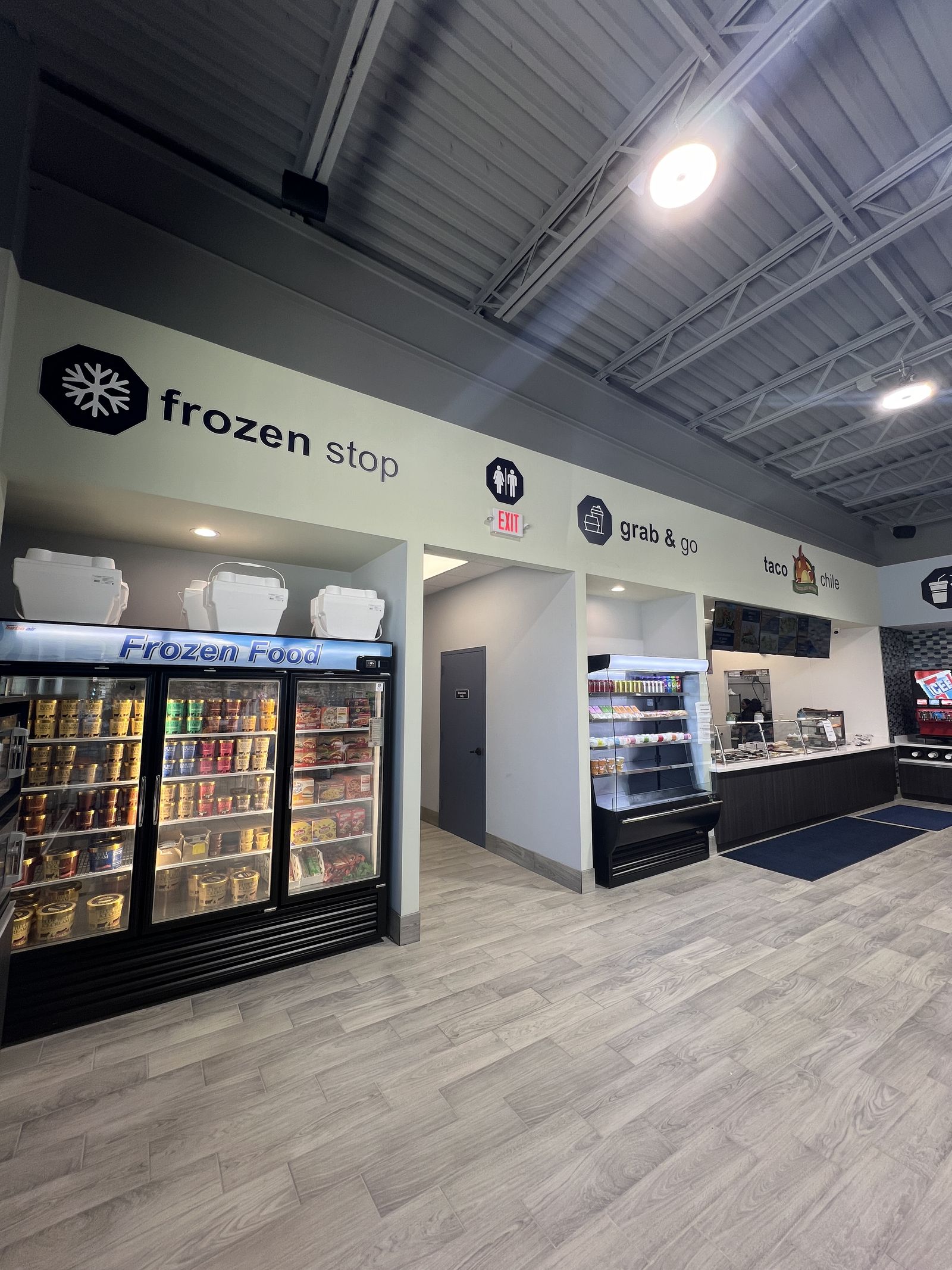 Frozen stop wayfinding signage above freezer section