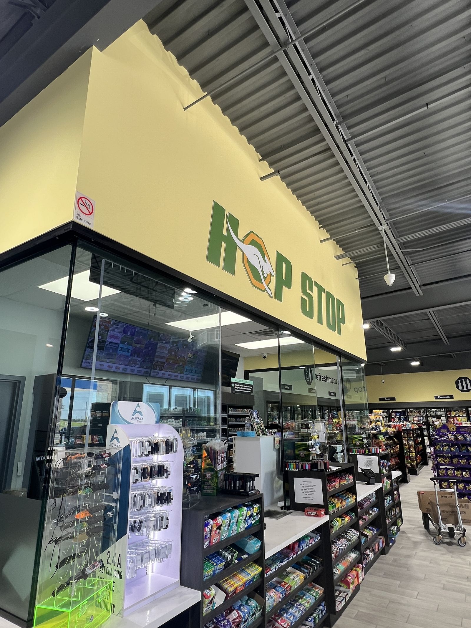 Illuminated Hop Stop counter sign in a convenience store