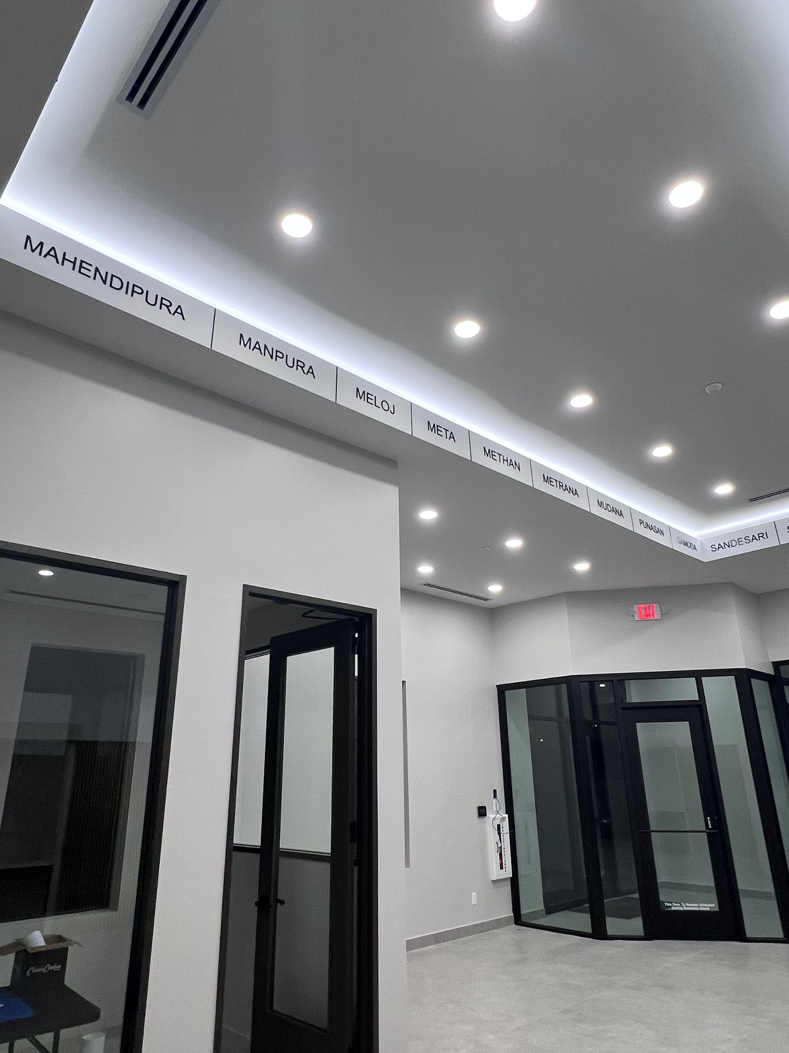 Interior signage during a retail buildout with cove lighting