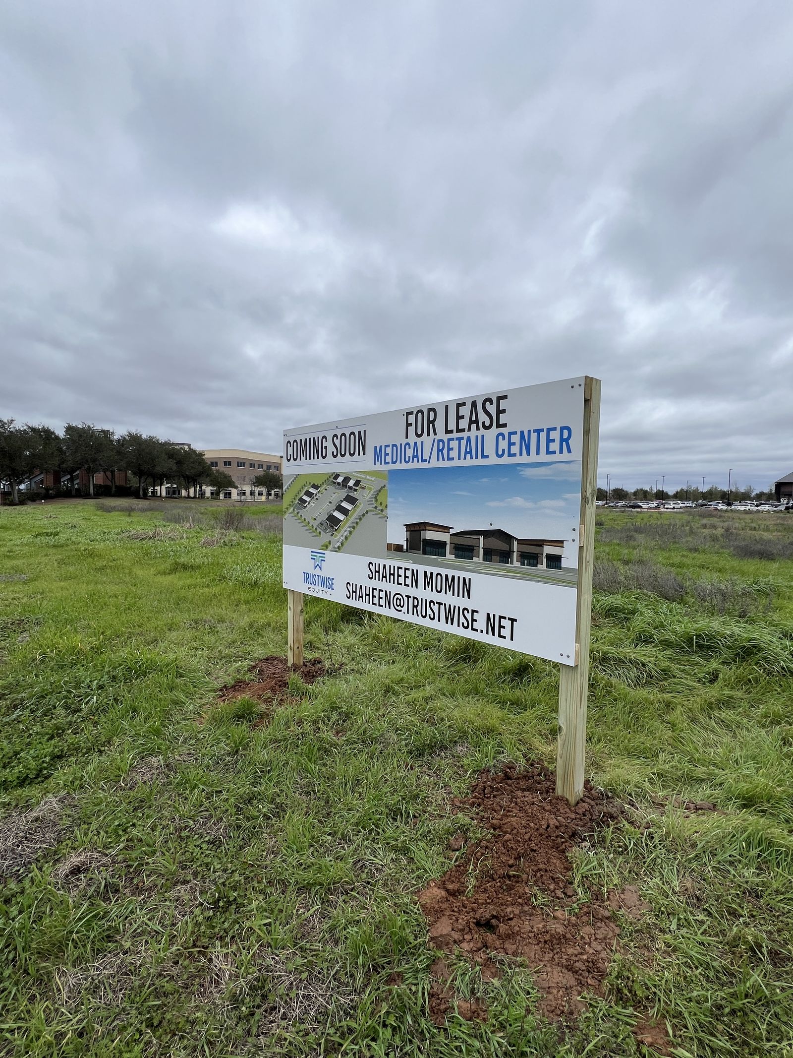 Coming soon and for-lease site sign at a retail development